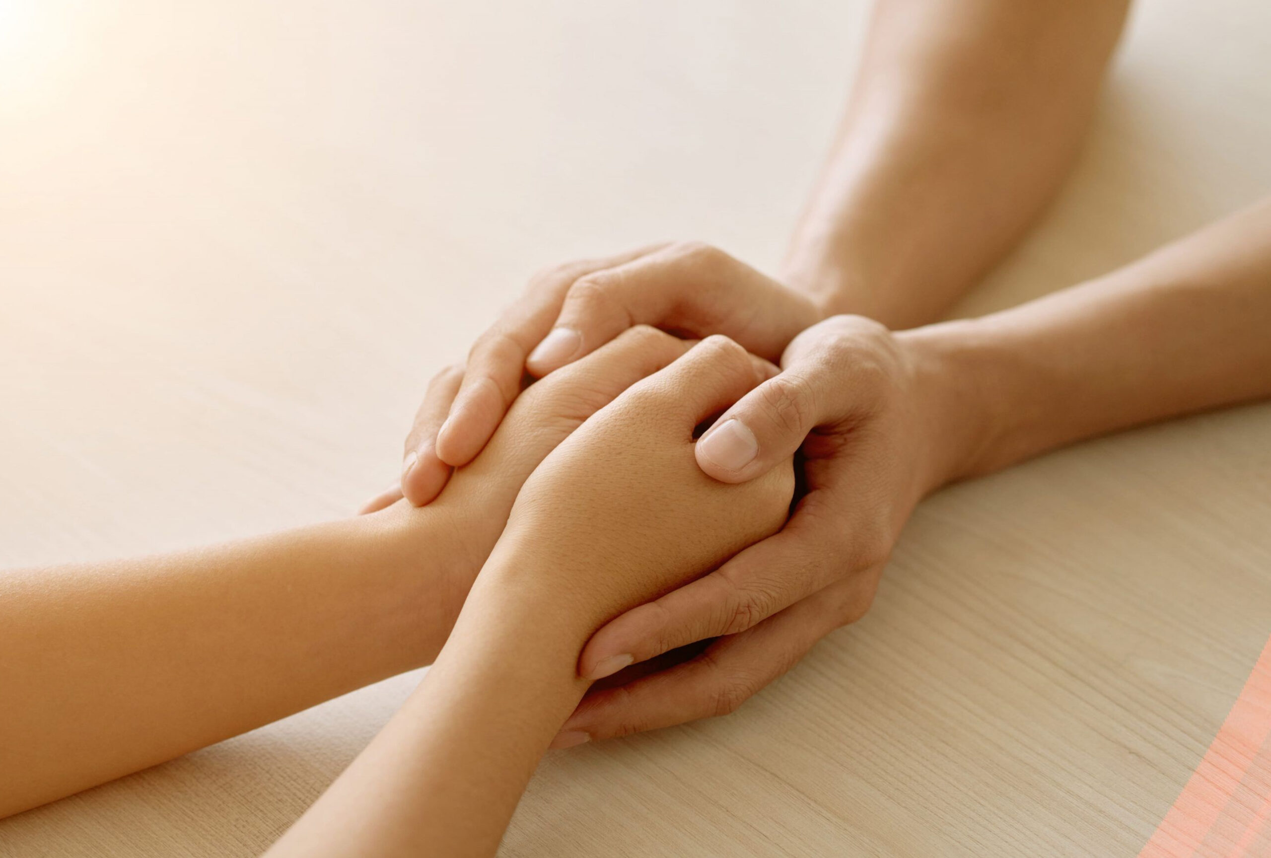 Shallow focus shot of a young blonde Caucasian woman in a wool cardigan